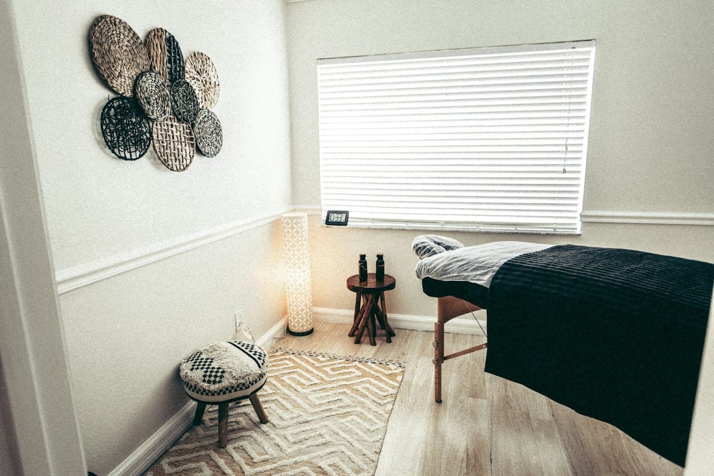 The treatment room: a made bed, warm towels and candlelight