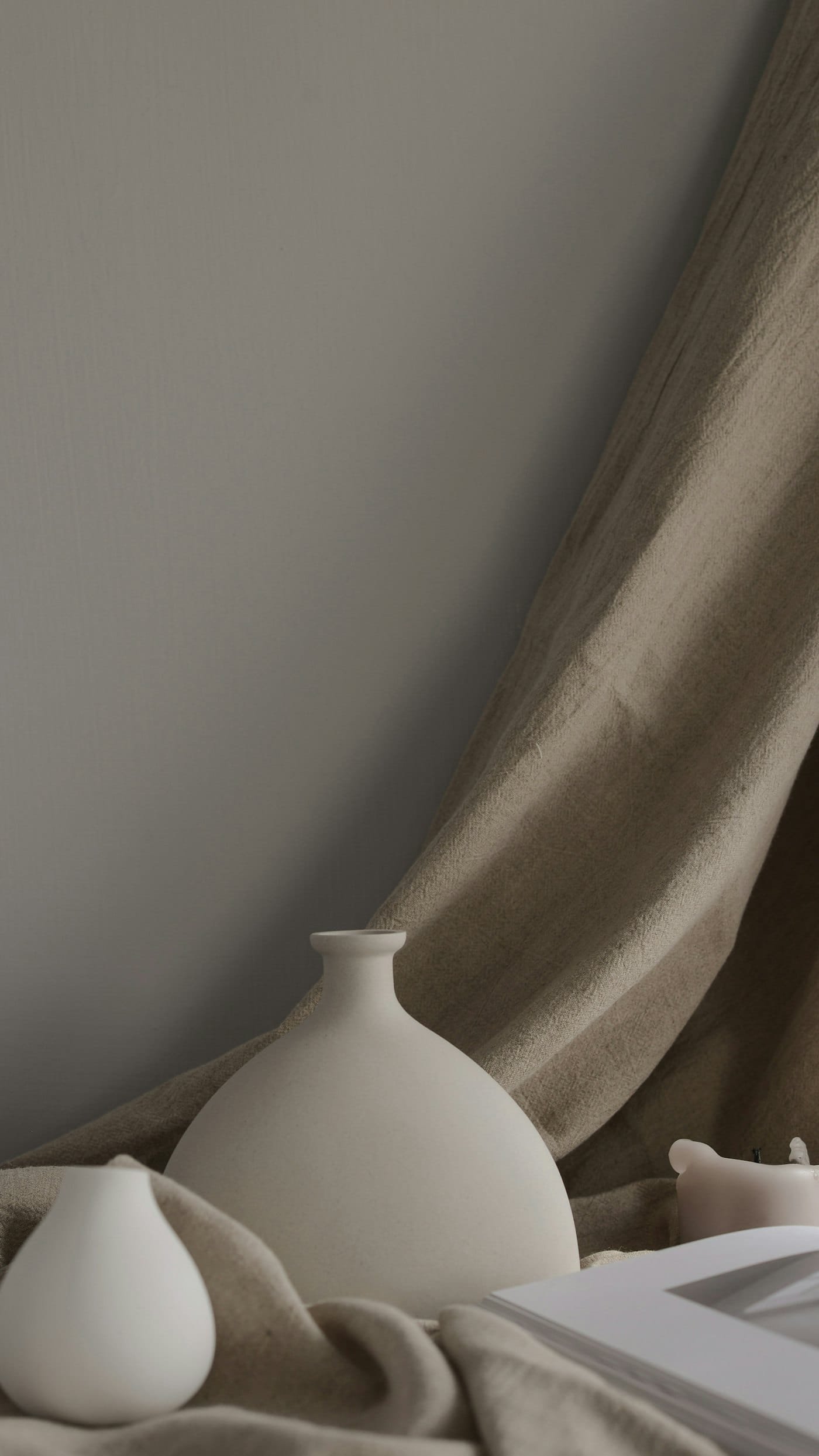 A ceramic vase on a draped table